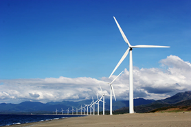 Wind turbines in front of a mountainous background